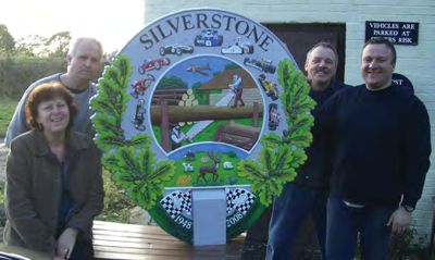The finished village sign with workers from Rock Artisan Foundry